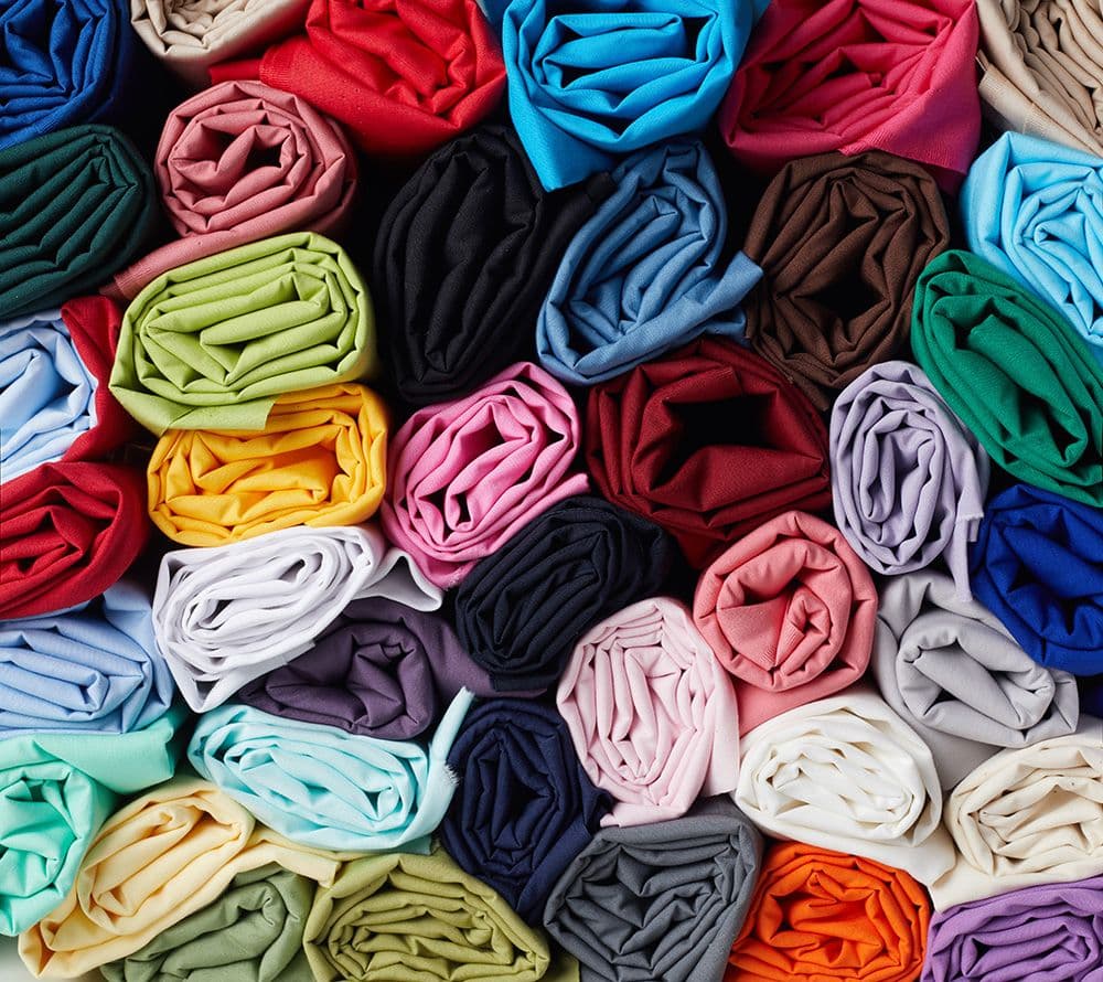 Rolls of solid-colour poplin fabric in multiple colours - Minerva