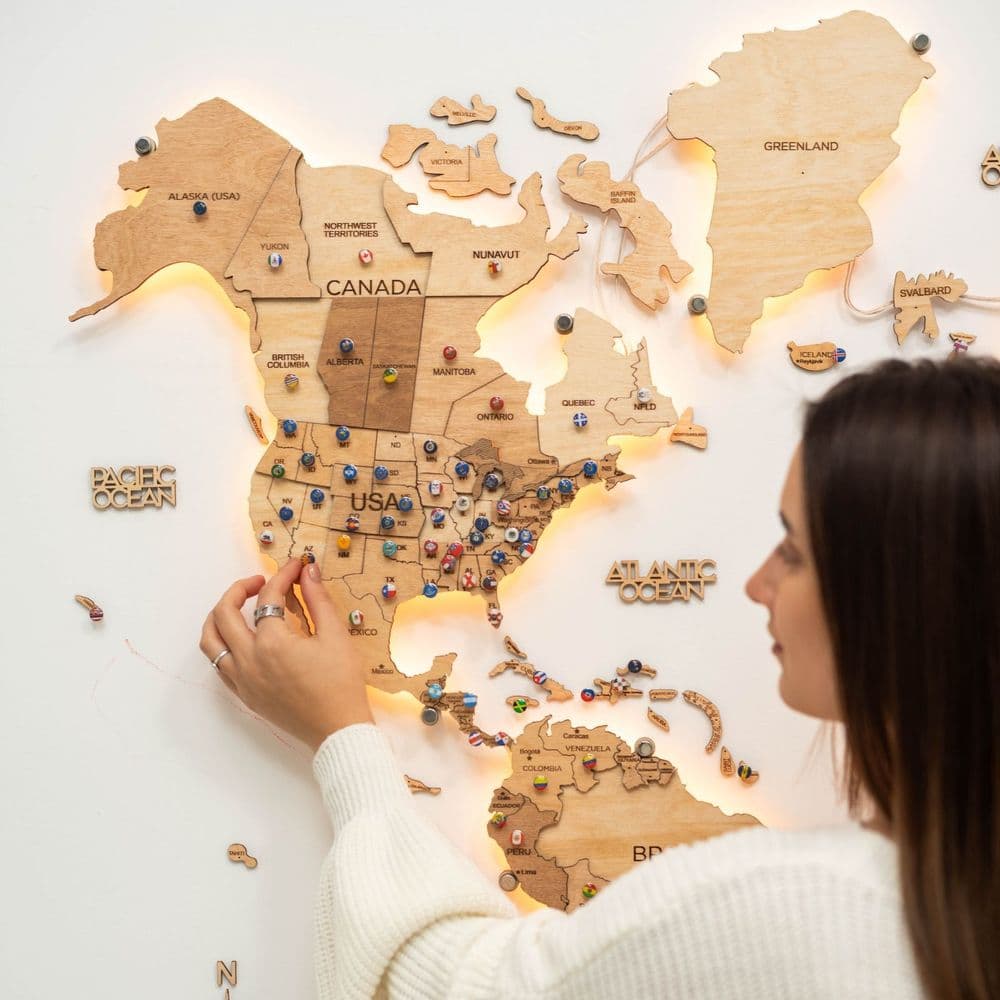 Enjoy The Wood 3D LED Wooden World Map 3.0 in Gold finish, backlit on a wall