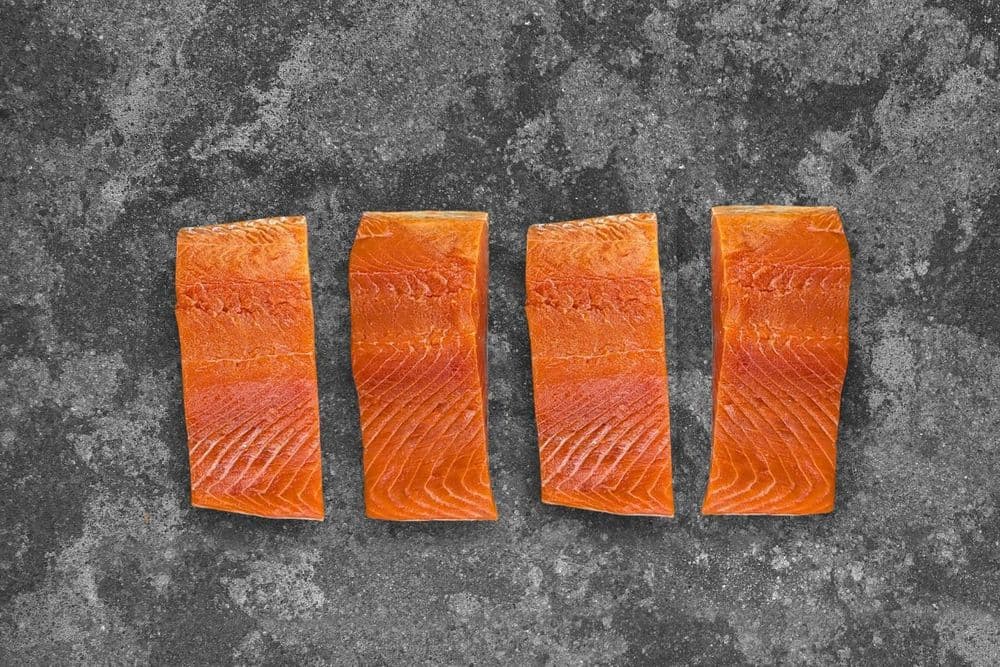 Four fillet portions of wild Alaskan Sockeye Salmon from Regal Fish Supplies, showing the deep ruby-red flesh
