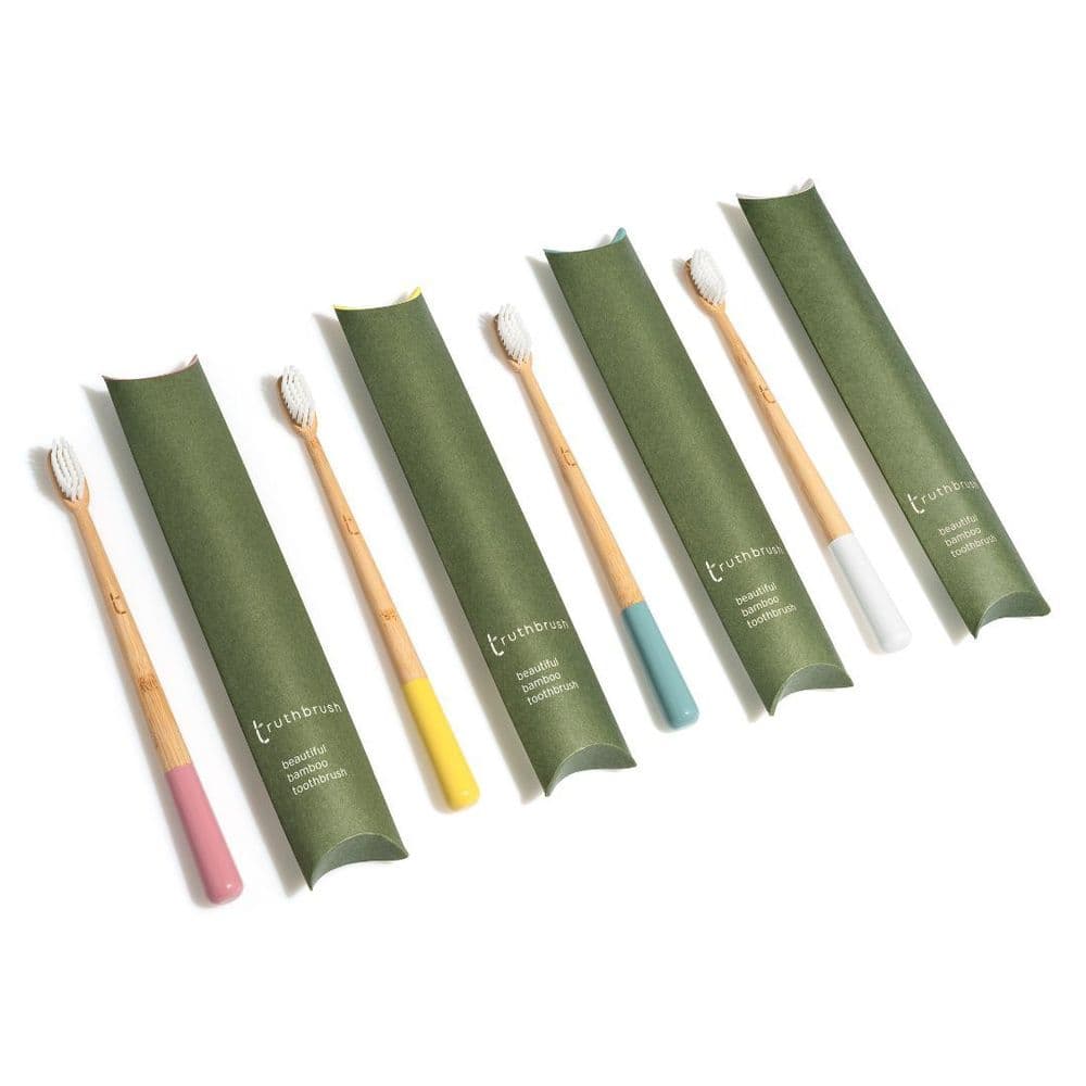 Truthbrush bamboo toothbrushes in green pillow packaging, multiple colours
